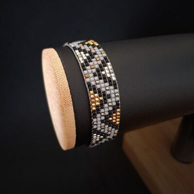 Ręcznie tkana bransoletka na krośnie – srebro i złoto – dodaj stylu każdej stylizacji. Perfekcyjna na wyjątkowe okazje oraz na co dzień. Wzór tkany na krośnie łączy elegancję z nowoczesnym charakterem. Idealna na prezent dla kobiety, która kocha luksus.